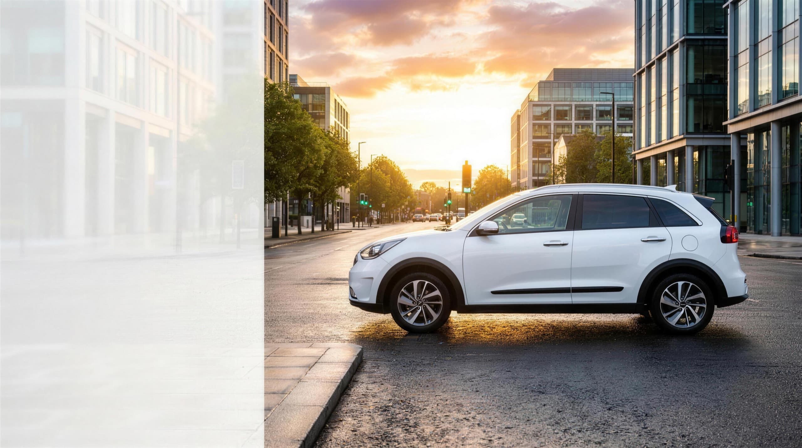 A white Kia Niro hybrid private-hire car on a golden-hour city street